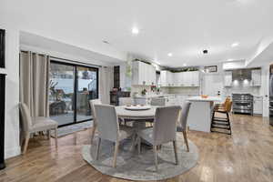 Dining area featuring light wood finished floors and recessed lighting