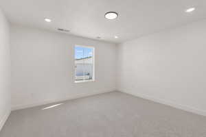 Unfurnished room featuring light carpet and recessed lighting