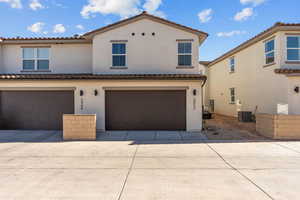 Mediterranean / spanish-style home with stucco siding, concrete driveway, a tile roof, and an attached garage