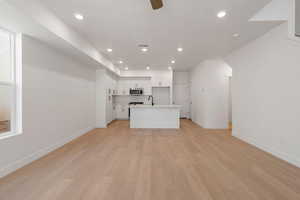 Unfurnished living room with recessed lighting, light wood-type flooring, and a ceiling fan
