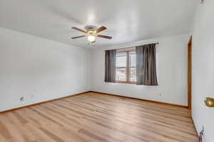 Spare room featuring wood finished floors and ceiling fan