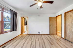 Spare room with wood finished floors and ceiling fan