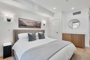 Bedroom with light wood-style floors and recessed lighting