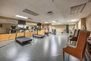 Workout area featuring a drop ceiling