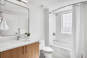 Full bath featuring vanity and shower / bathtub combination with curtain