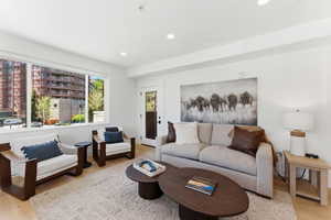 Light wood-finish flooring complements the neutral wall tones of this living space