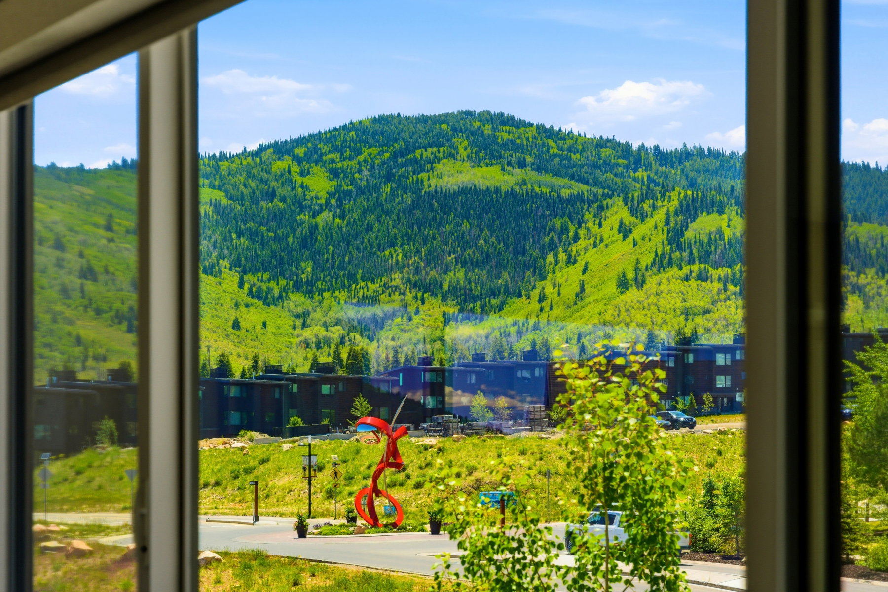 Framed mountain scenery featuring abundant green foliage