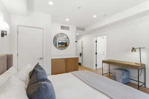 Interior featuring white walls, recessed lighting, and wood-finish flooring