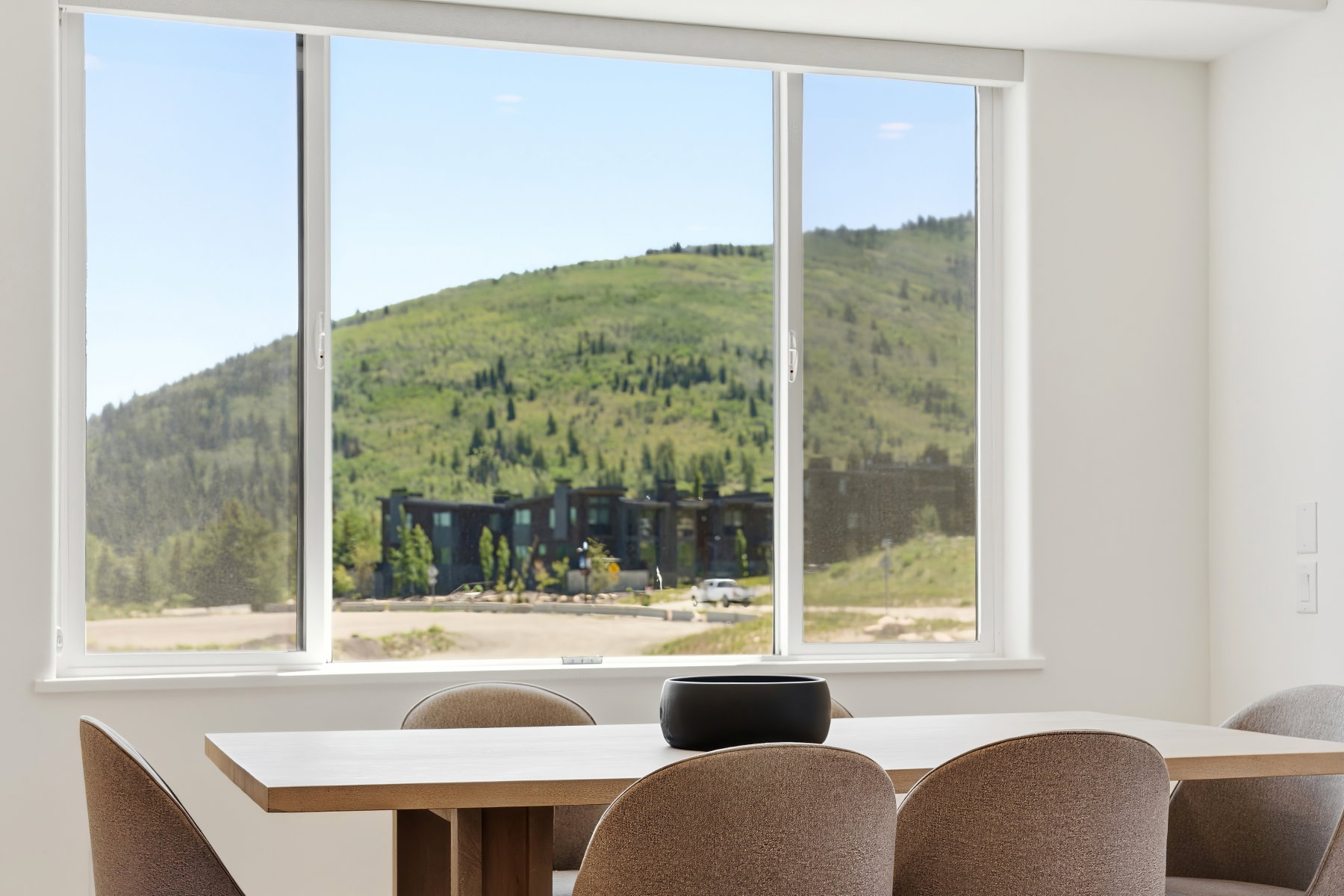 Expansive triple-pane window with a white frame, offering abundant natural light
