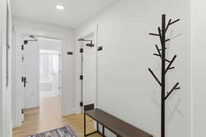 Entryway featuring light wood-finish flooring, white walls, and recessed lighting