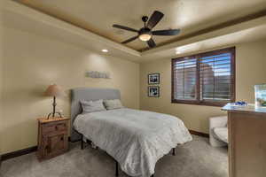 Bedroom featuring recessed lighting, carpet floors, ceiling fan, and a tray ceiling