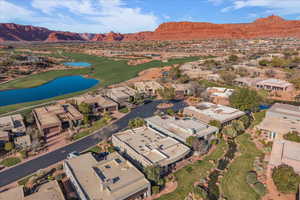 Aerial view of property and surrounding area with a water and mountain view and nearby suburban area