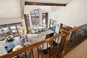 Living area with stairway, high vaulted ceiling, wood-type flooring, beam ceiling, and recessed lighting