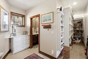 Hallway featuring baseboards