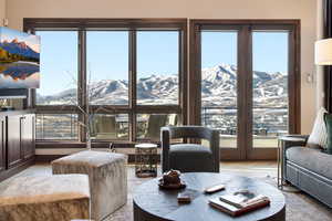 Living room featuring a mountain view, plenty of natural light, and wood finished floors