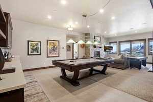 Rec room with billiards table, recessed lighting, light carpet, and a fireplace