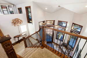 Staircase featuring a high ceiling and wood finished floors