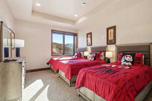 Bedroom featuring a tray ceiling, carpet floors, and recessed lighting