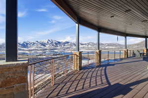 Snow covered deck with a mountain view