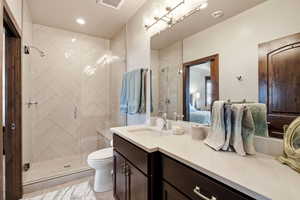 Full bath featuring vanity, ensuite bath, a stall shower, and recessed lighting