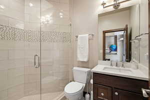 Bathroom featuring a stall shower and vanity