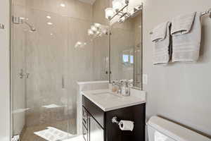 Bathroom featuring vanity and a stall shower
