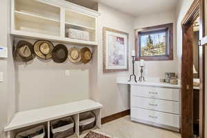 Mudroom with baseboards and light tile patterned floors