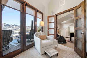 Living area with french doors, carpet, and a mountain view