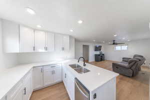 Kitchen featuring open floor plan, recessed lighting, light wood finished floors, and white cabinets