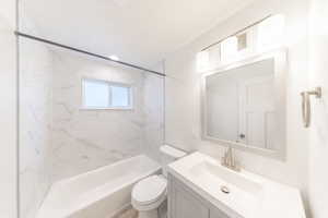 Bathroom featuring vanity, tub / shower combination, and a textured ceiling