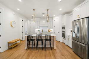 Gourmet kitchen with gas cook top, hood, stainless steel appliances