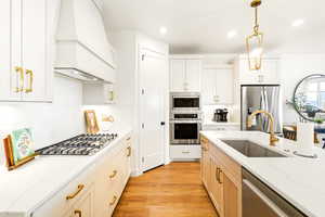 Gourmet kitchen with gas cook top, hood, stainless steel appliances