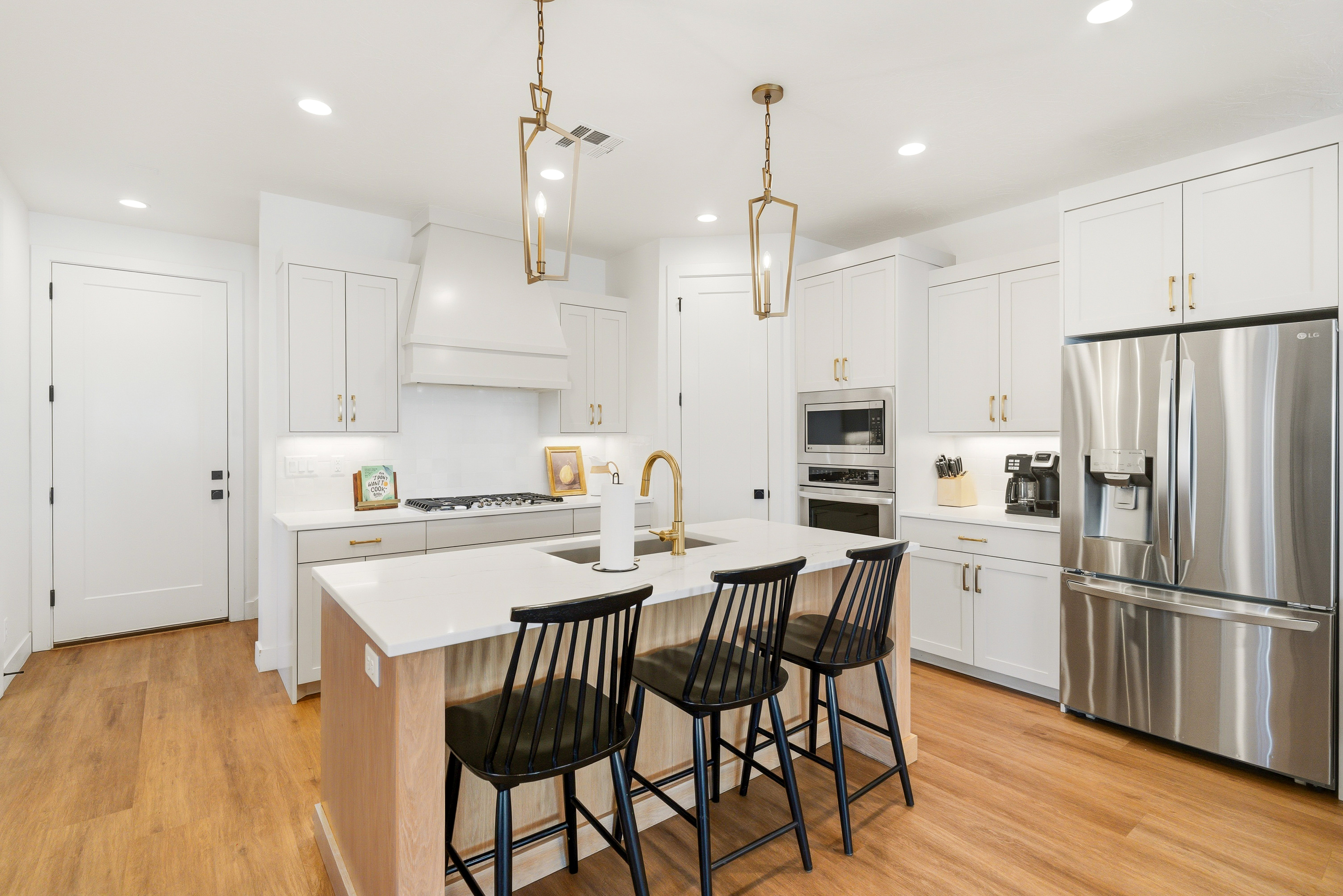 Gourmet kitchen with gas cook top, hood, stainless steel appliances