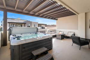 Upper patio with fire pit, hot tub, and TV