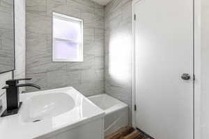 Full bath featuring vanity, dark wood finished floors, and bathtub / shower combination