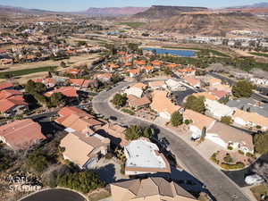Aerial view of property and surrounding area featuring a water and mountain view and nearby suburban area
