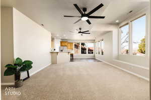 Unfurnished living room with light colored carpet, recessed lighting, a textured ceiling, and ceiling fan