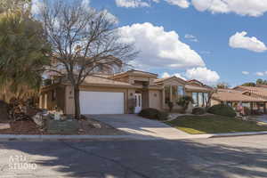 Mediterranean / spanish home featuring stucco siding, concrete driveway, a garage, a tiled roof, and a front yard