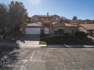 Mediterranean / spanish-style house with concrete driveway, a tile roof, a chimney, and an attached garage