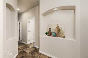 Hallway with recessed lighting and dark stone finish floors