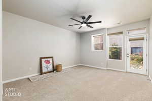 Spare room with light carpet and ceiling fan