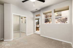 Unfurnished bedroom featuring a closet, carpet floors, and ceiling fan