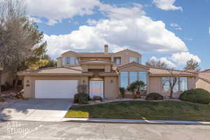 Mediterranean / spanish-style home featuring stucco siding, driveway, a front lawn, an attached garage, and a tile roof