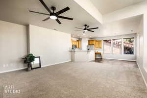 Unfurnished living room featuring a chandelier, light carpet, a textured ceiling, and a ceiling fan