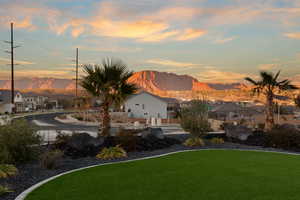 View of green lawn featuring a residential view and a mountain view