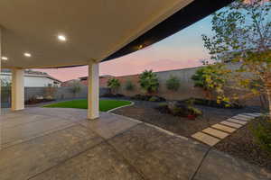 Patio terrace at dusk featuring a fenced backyard and a patio