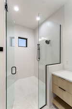 Full bath featuring a shower stall and vanity