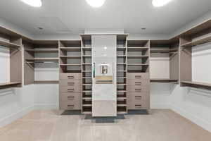 Walk in closet featuring light colored carpet