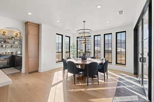Dining room featuring light wood-style flooring, recessed lighting, and a chandelier