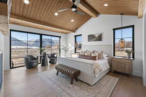 Bedroom featuring a mountain view, wood finished floors, wooden ceiling, recessed lighting, and multiple windows